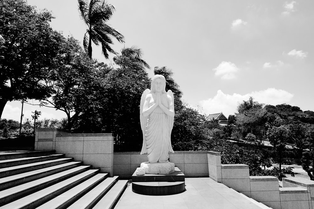 woman in white wedding dress standing on concrete bench