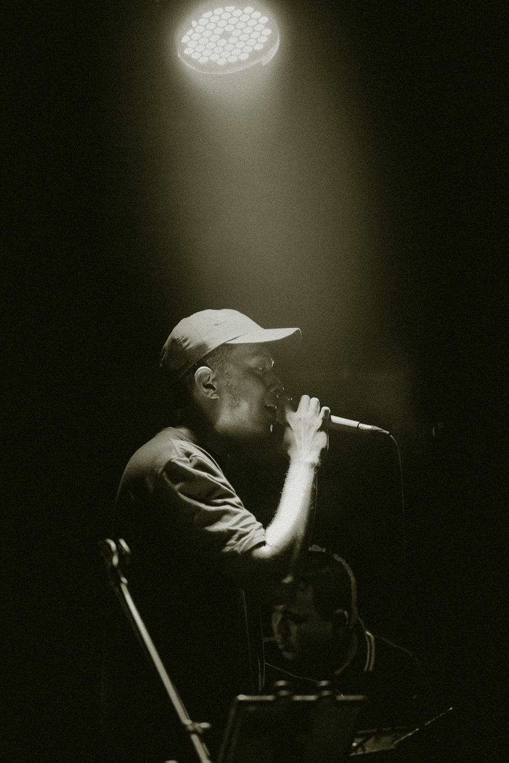 man in black hat singing