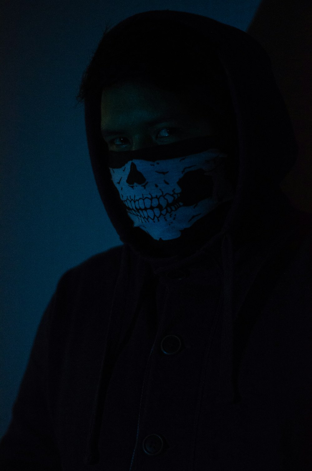 man in black hoodie with face mask