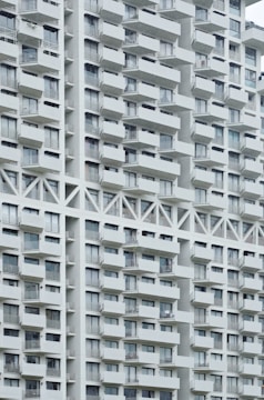 Exterior view of a sleek apartment complex with balconies overlooking the city.