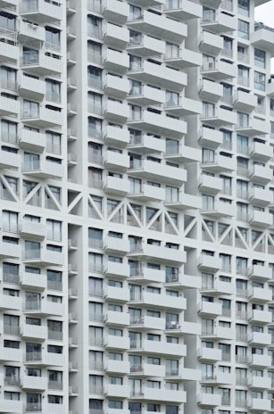 Exterior view of a well-maintained apartment building with balconies.