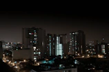 A nighttime cityscape illuminated by warm lights, reflecting the company's commitment to working through all hours.