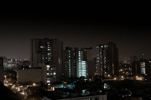 A nighttime cityscape illuminated by warm lights, reflecting the company's commitment to working through all hours.