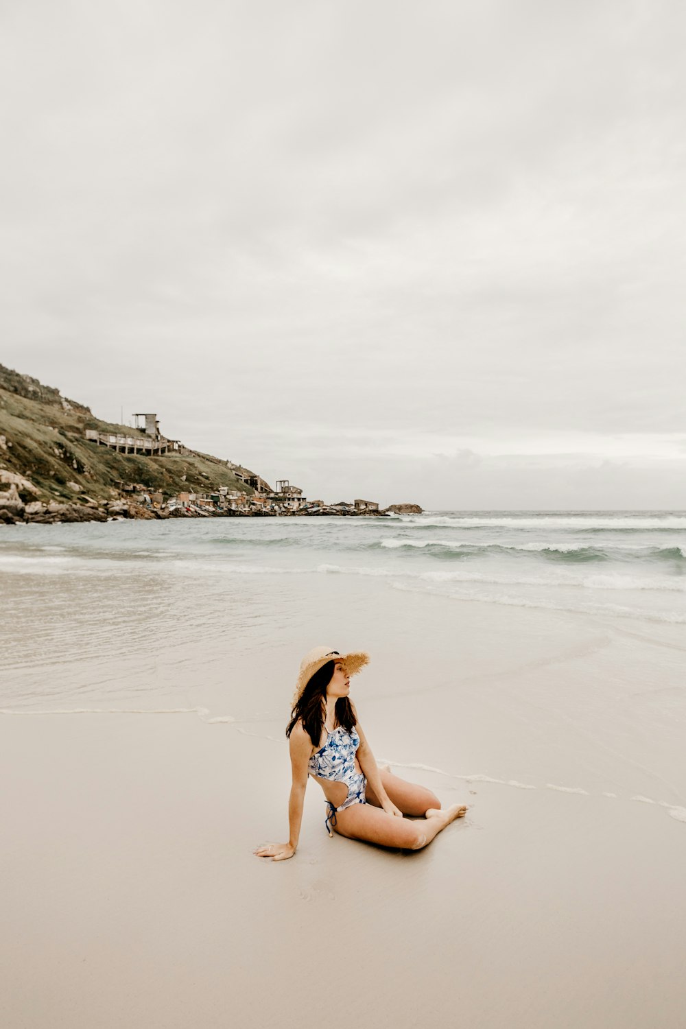 woman in blue bikini sitting on beach during daytime