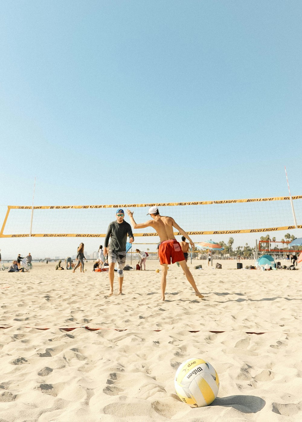 people playing volleyball on beach during daytime