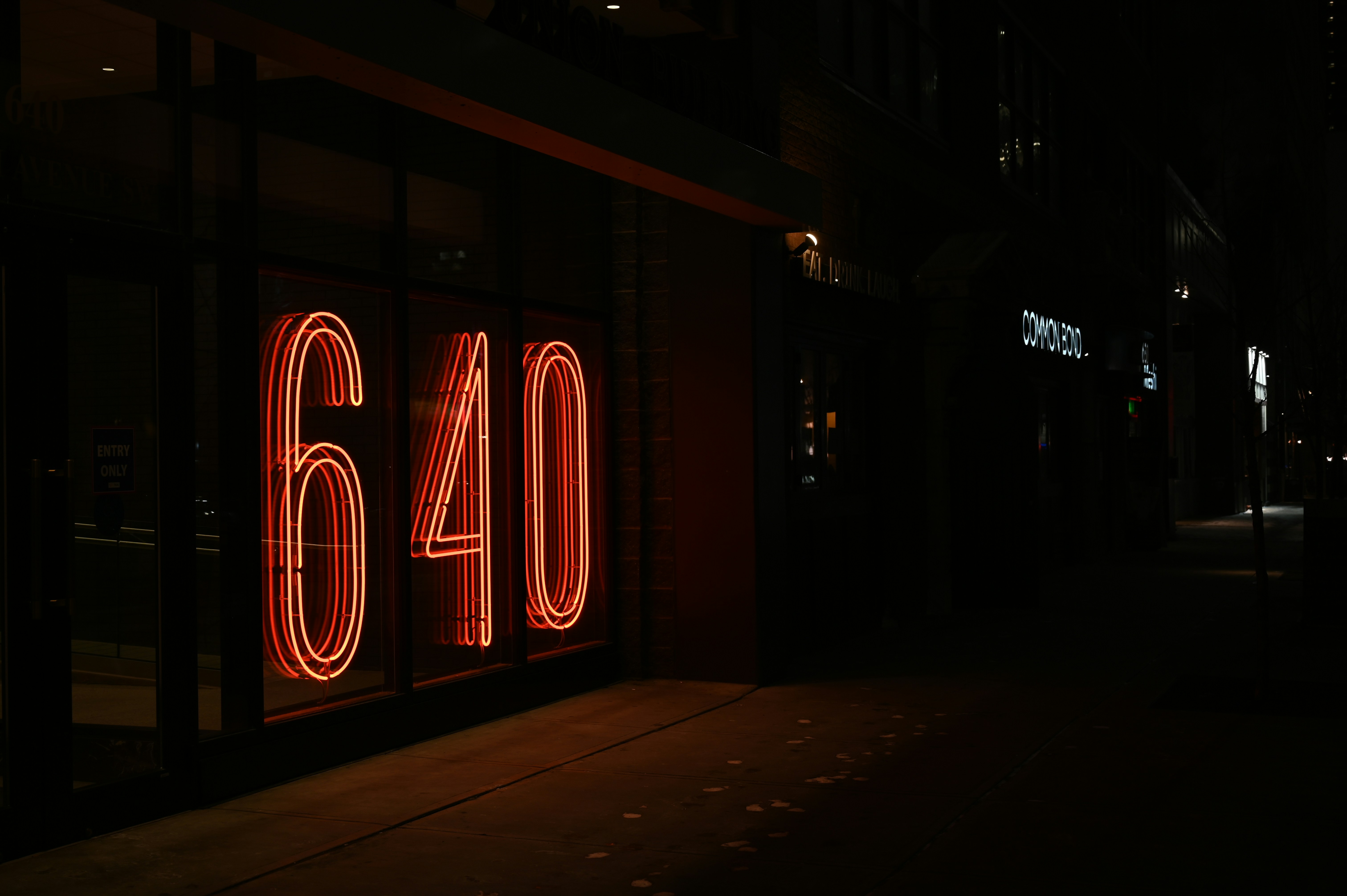 a neon sign that reads sixty on the side of a building