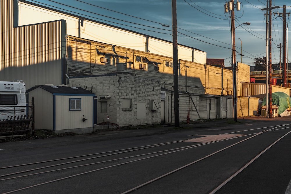 white and gray concrete building beside train rail during daytime