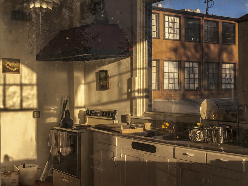 stainless steel sink beside brown wooden framed glass window