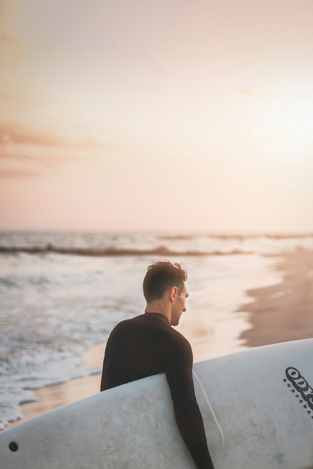 man in black shirt sitting on white boat looking at the sea during daytime