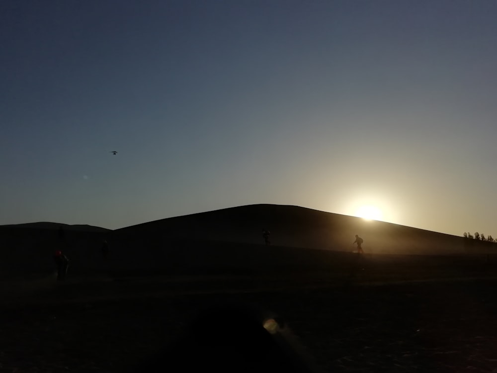 silhouette of mountain during night time