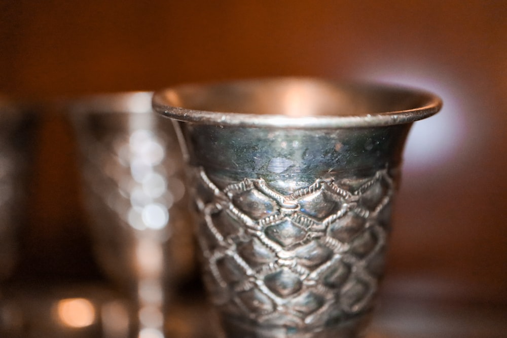 silver round bowl on brown wooden table