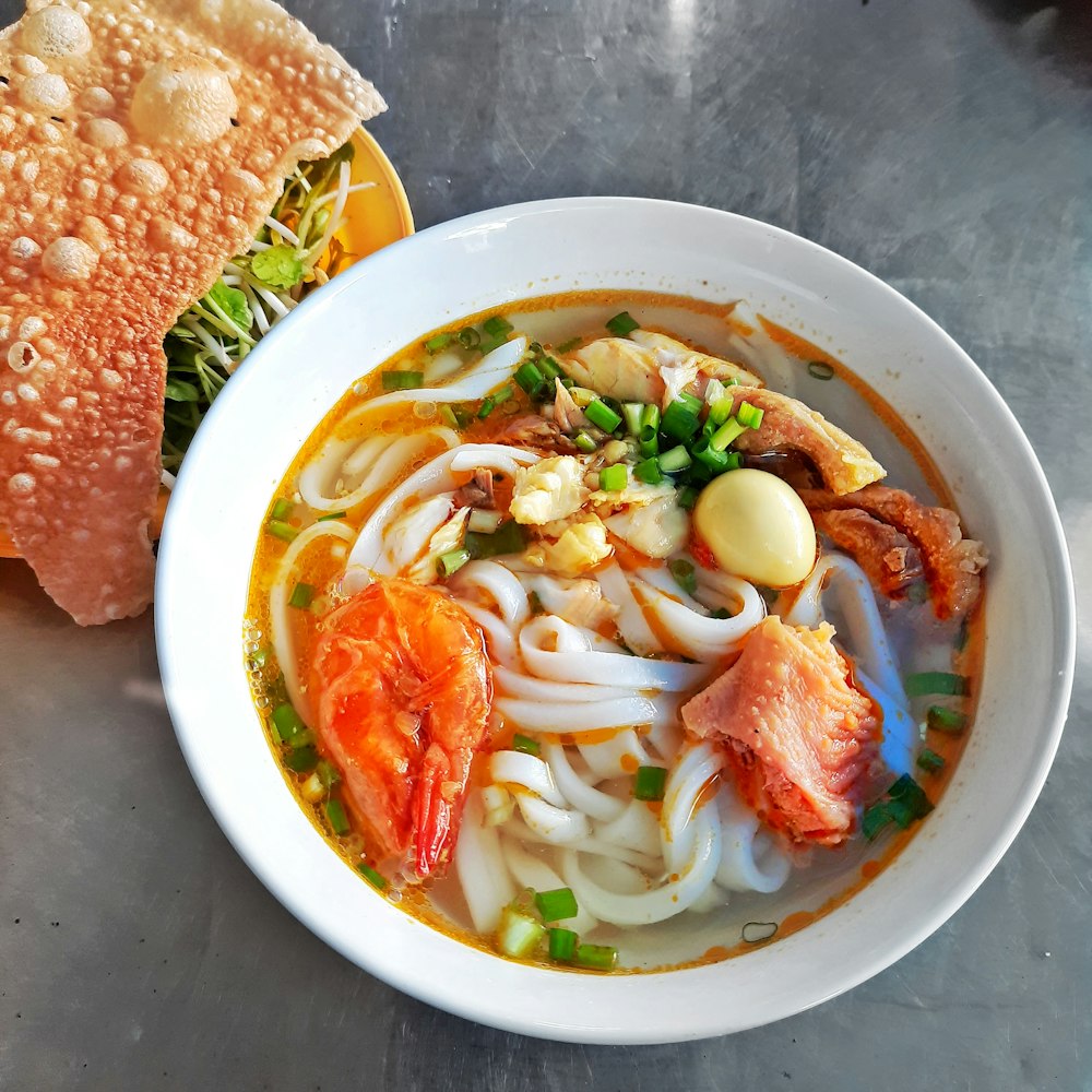 soup with sliced bread on white ceramic bowl