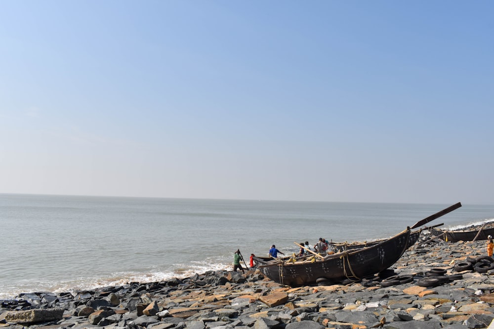 brown canoe on shore during daytime