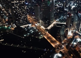 Night view of Buenos Aires skyline with illuminated landmarks and lively streets.