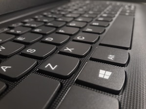 Close-up of a hand pressing Windows key and D on a keyboard to show desktop instantly.