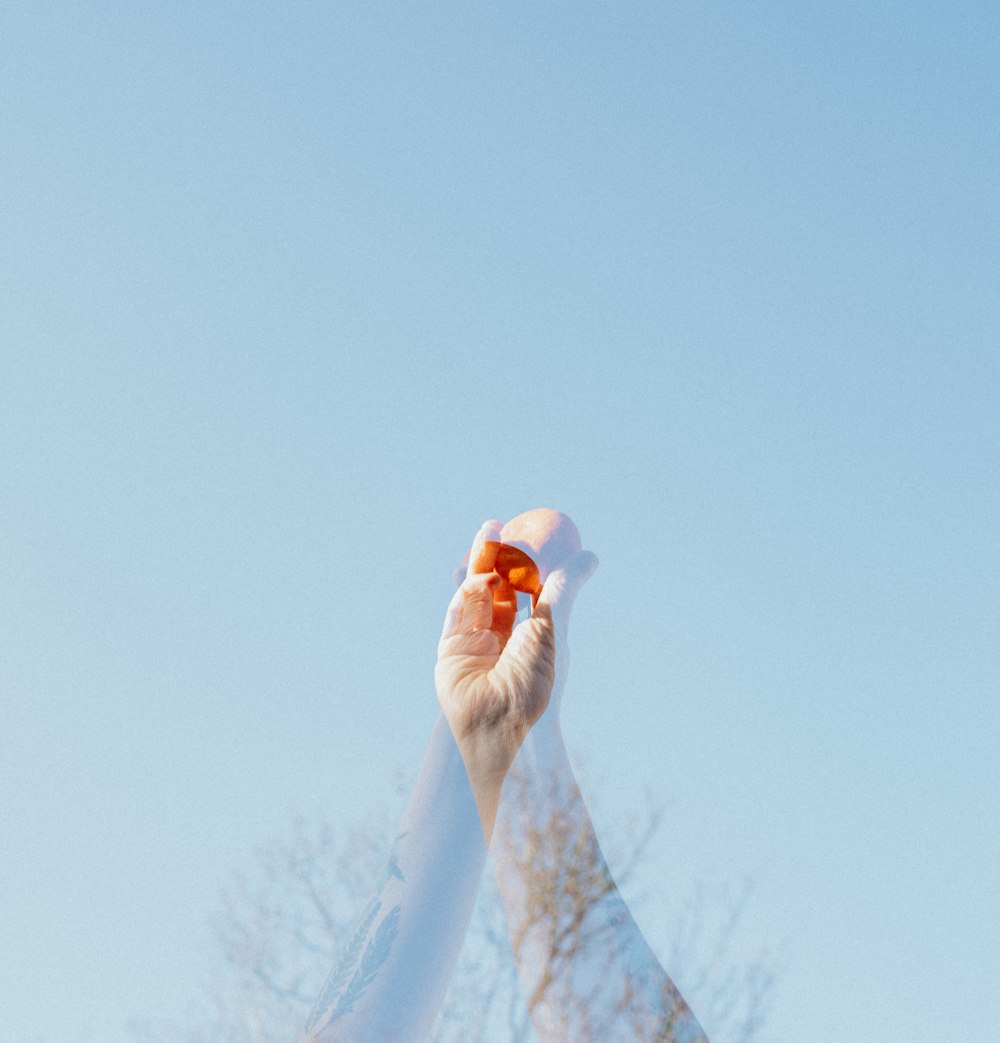 person holding white snow on hand during daytime