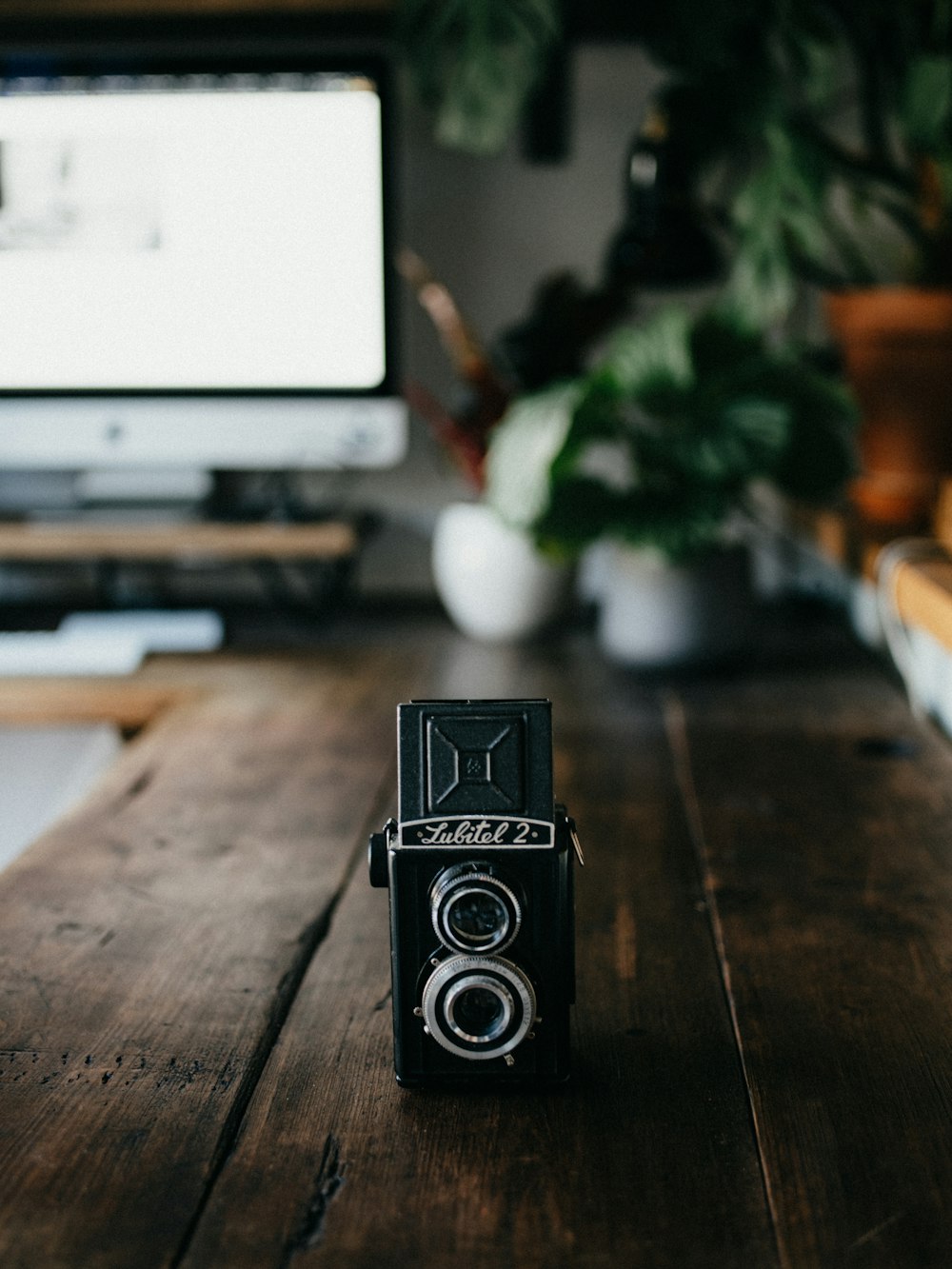 black and silver speaker on brown wooden table