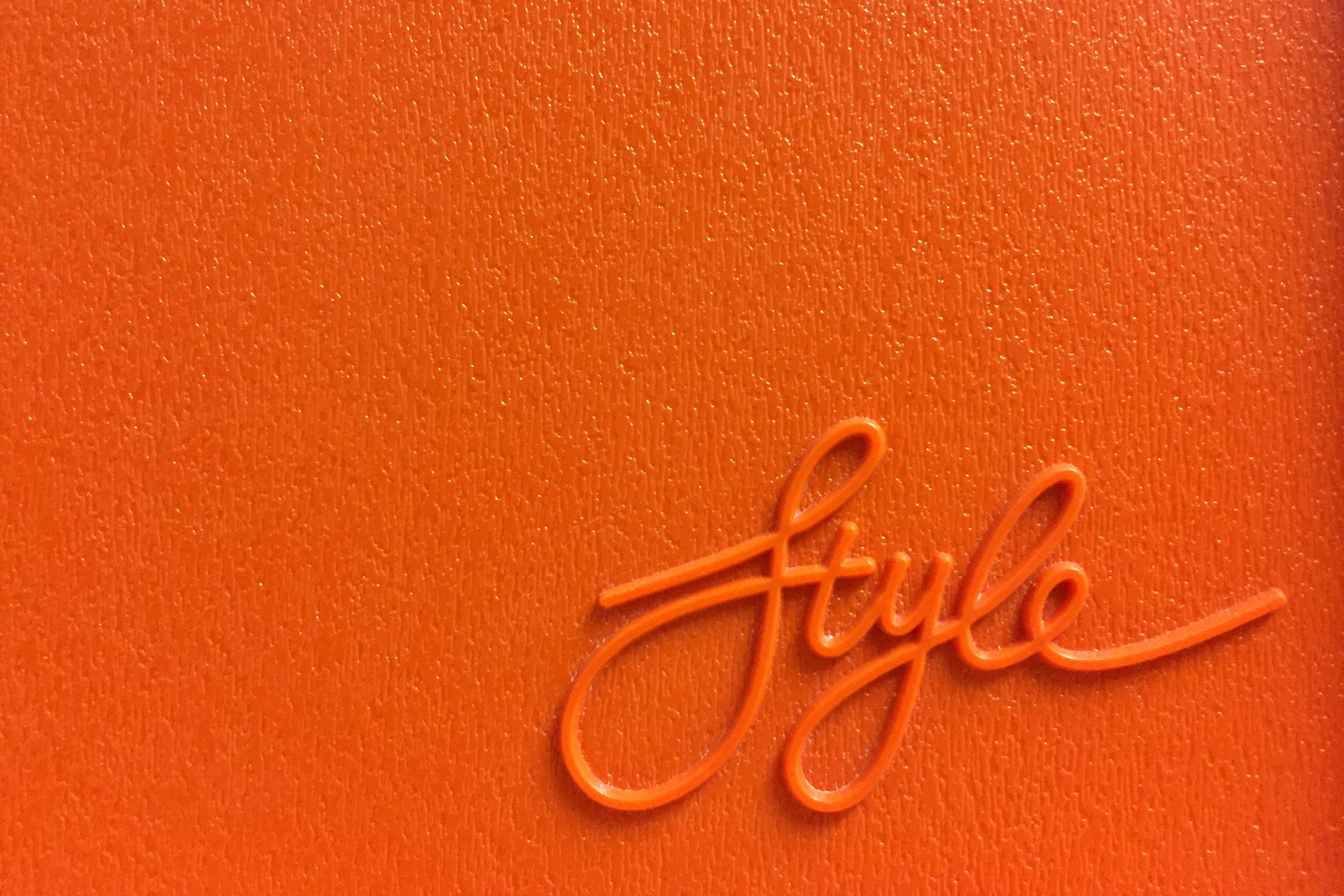 Orange Style lettering on a vintage plastic board