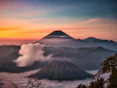snow covered mountain during sunset