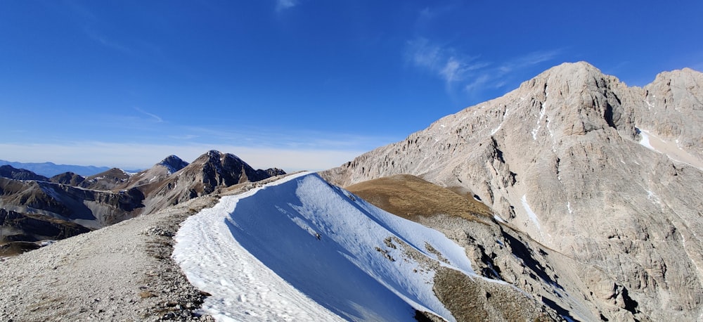 snow covered mountain under blue sky during daytime