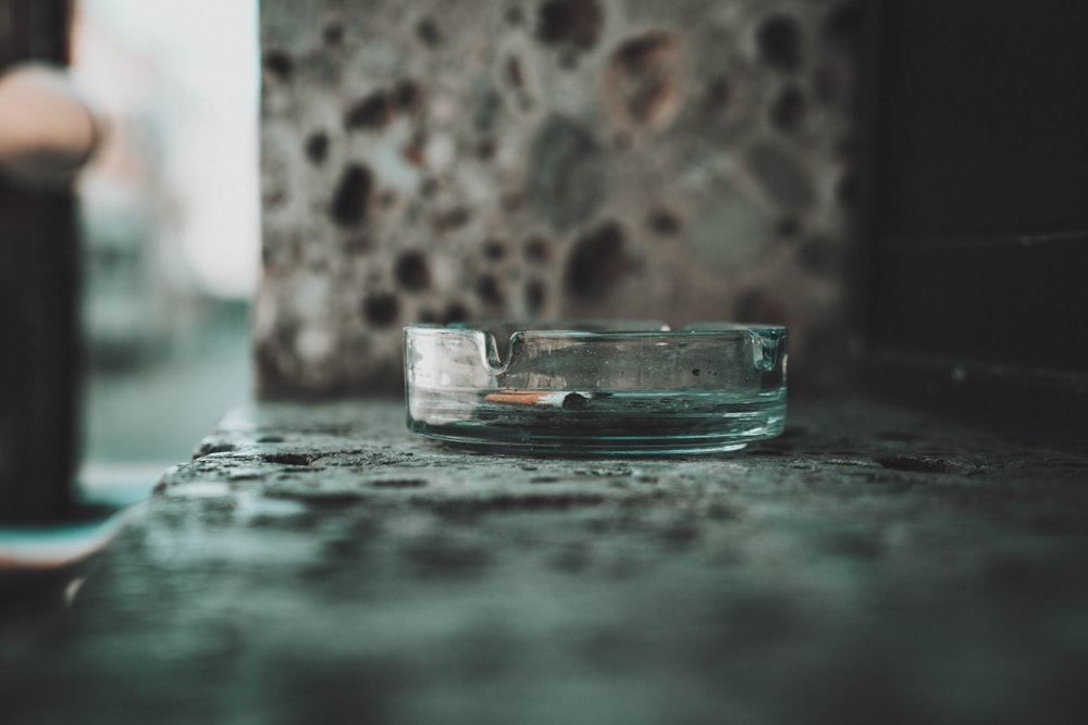 clear glass on gray and black marble table