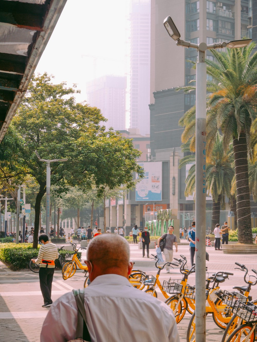 people walking on sidewalk near buildings during daytime