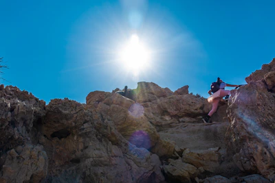 Climber guiding a group on a sunny limestone cliff near Grenoble.