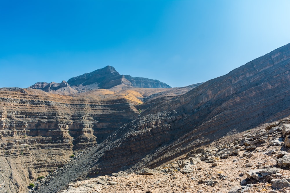 brown rocky mountain under blue sky during daytime