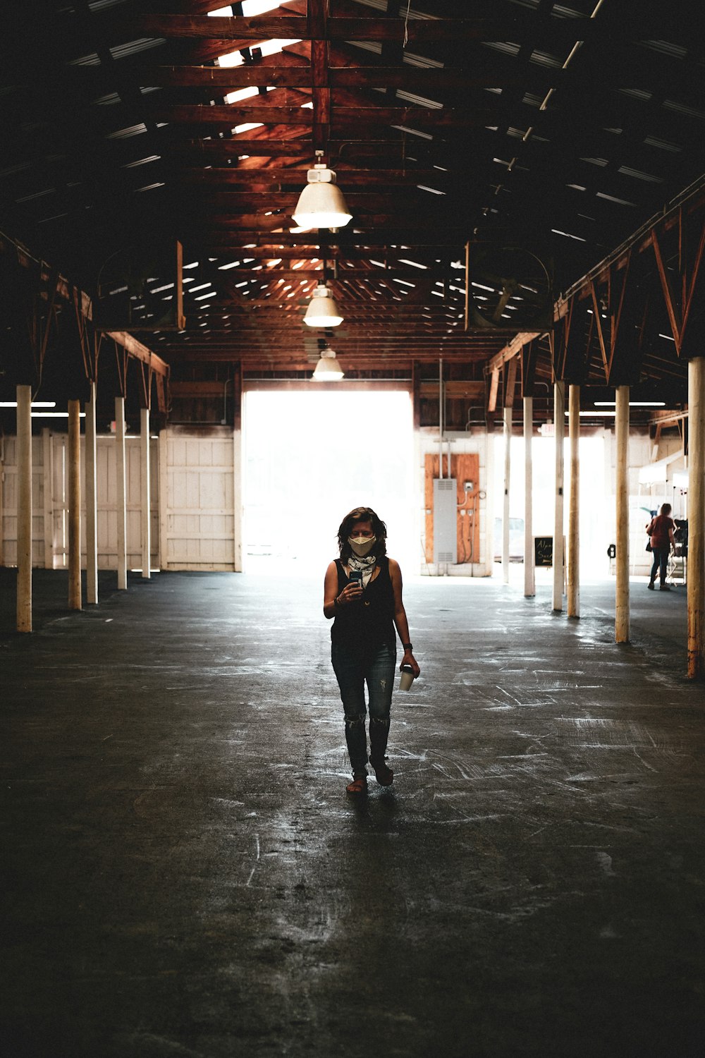 woman in black jacket standing on hallway