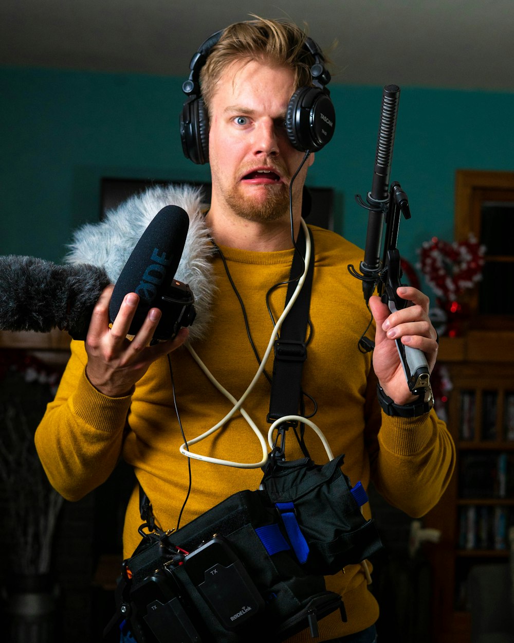 man in yellow long sleeve shirt holding microphone