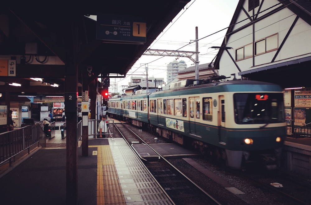 white and red train on train station during daytime