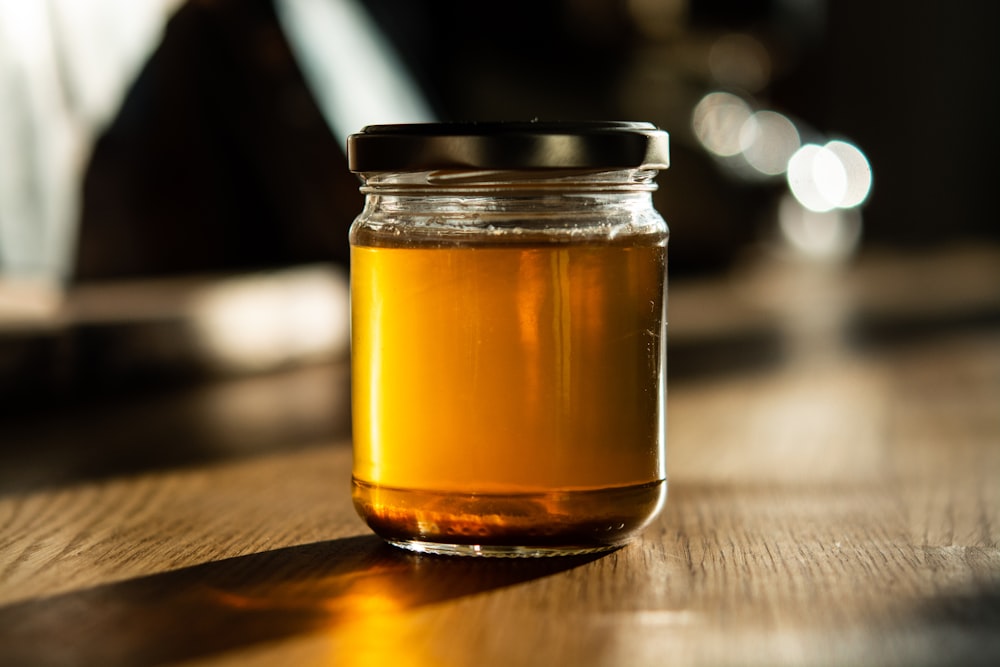 clear glass jar with brown liquid inside