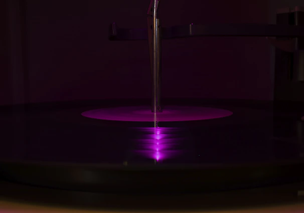 Moody, cinematic shot of a pristine vinyl pressing machine in action.