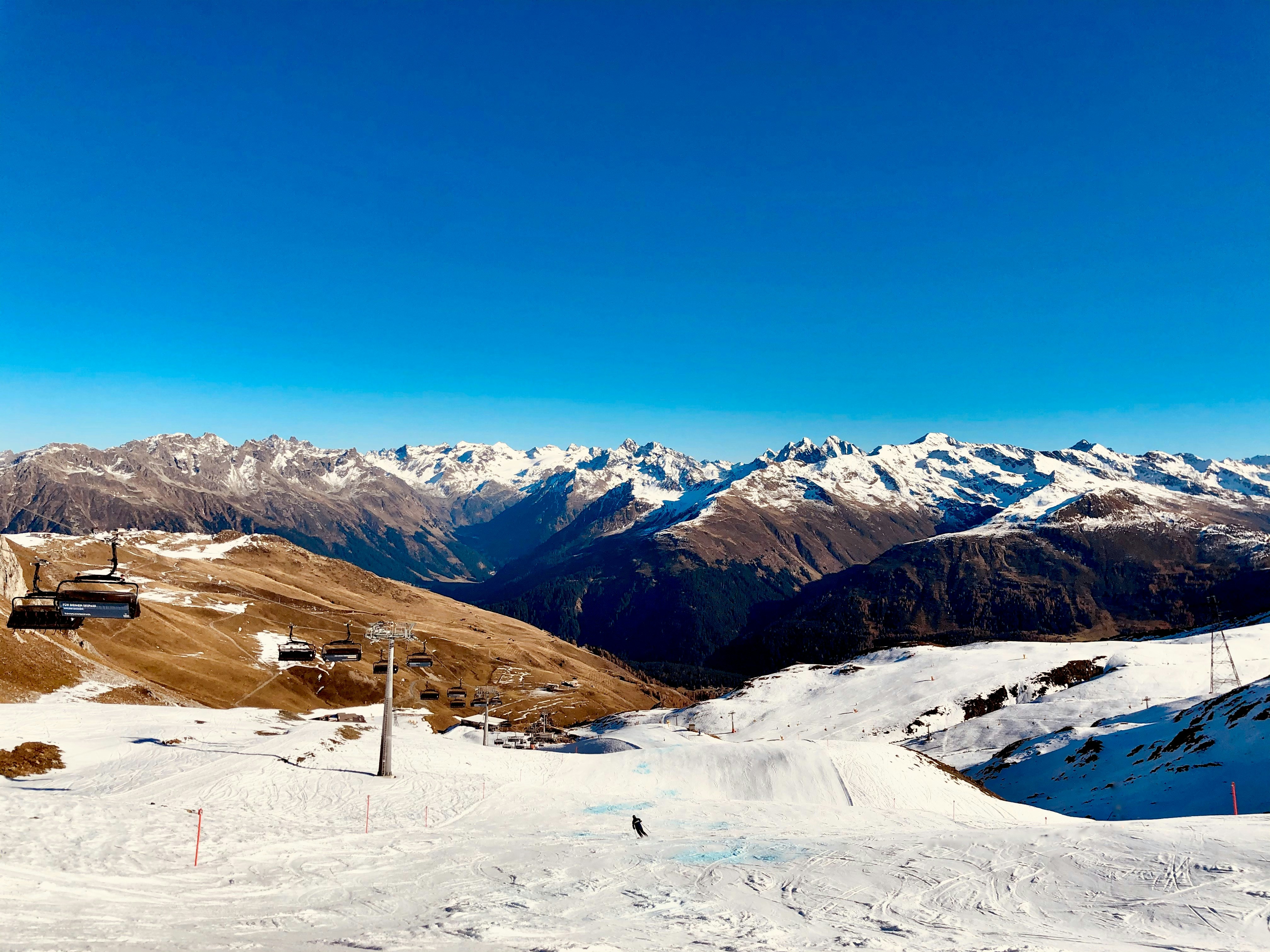 snow covered mountains under blue sky during daytime