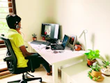 An expert sitting at a desk with a headset, ready to assist customers 24x7.