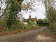 A charming cottage surrounded by trees.