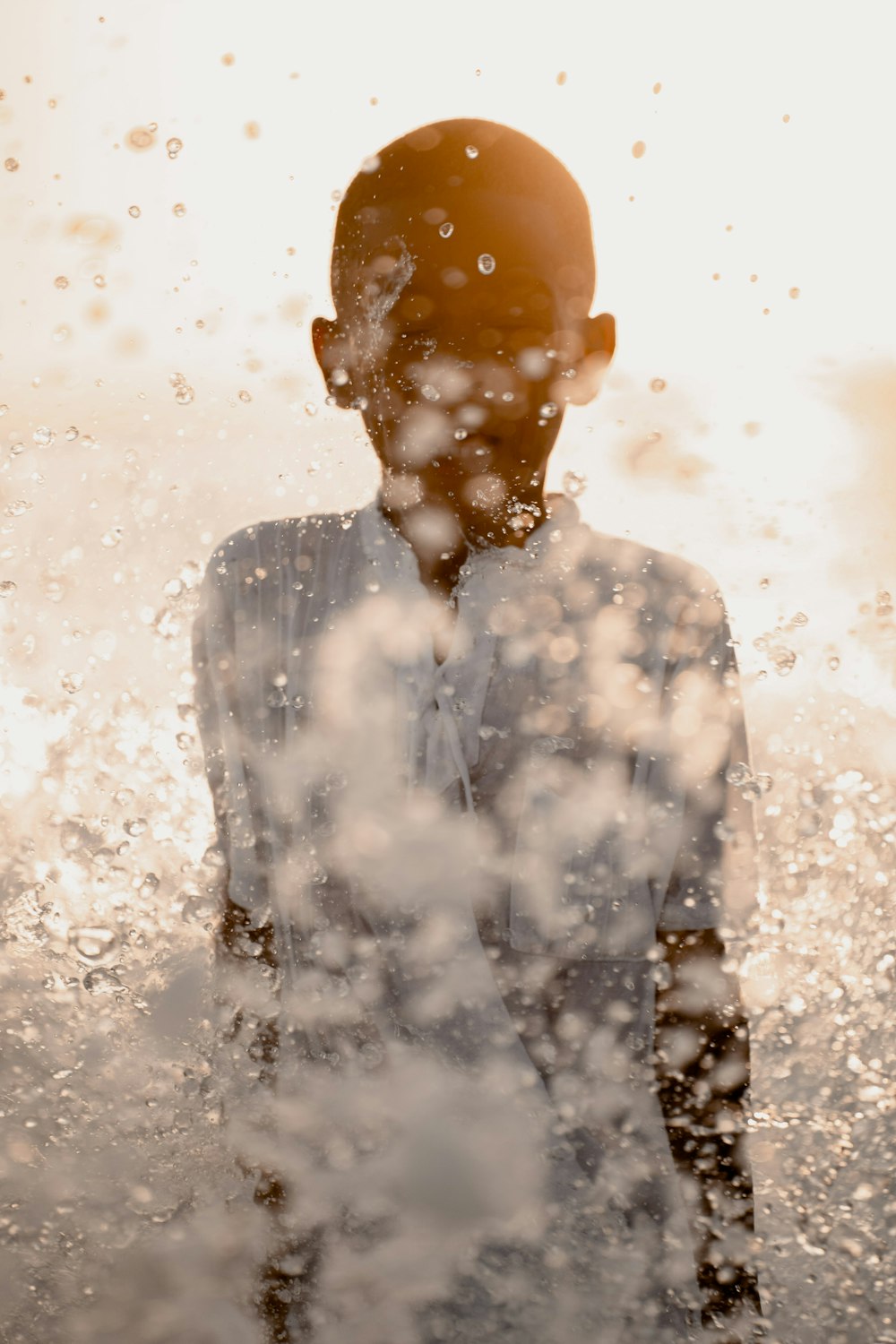 man in black jacket standing on water