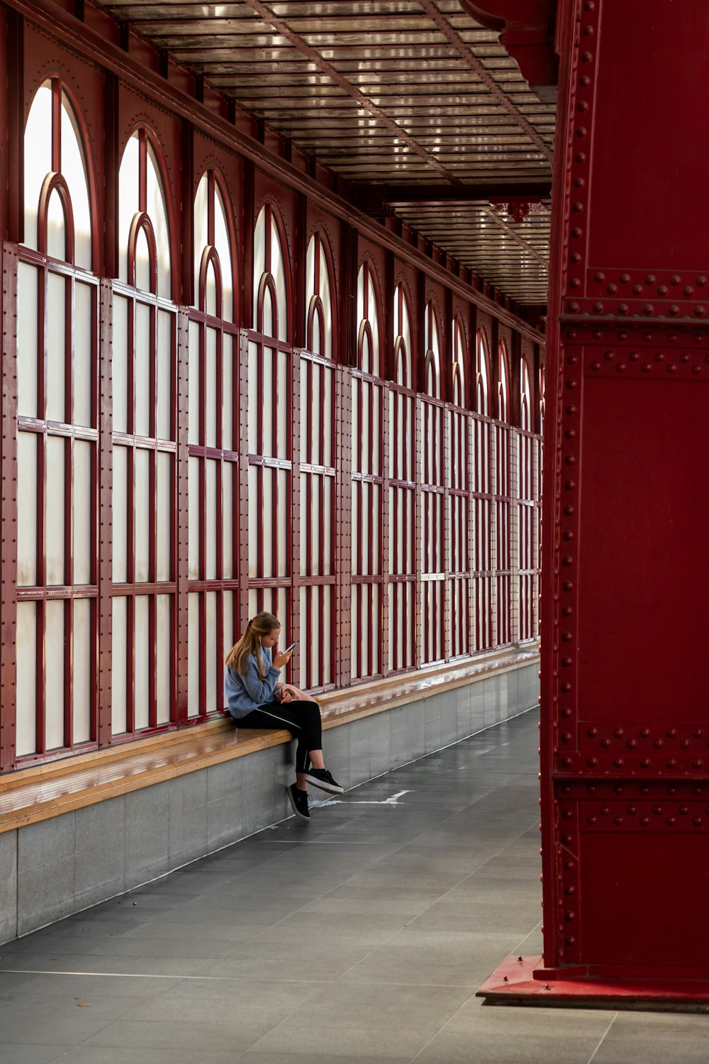 woman in blue long sleeve shirt sitting on bench