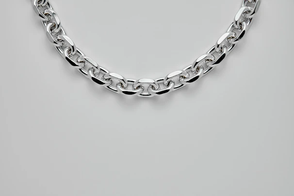 Close-up of a sleek pure platinum chain reflecting soft light.