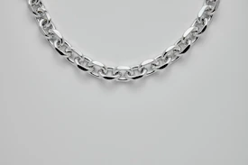 silver chain link bracelet on white surface