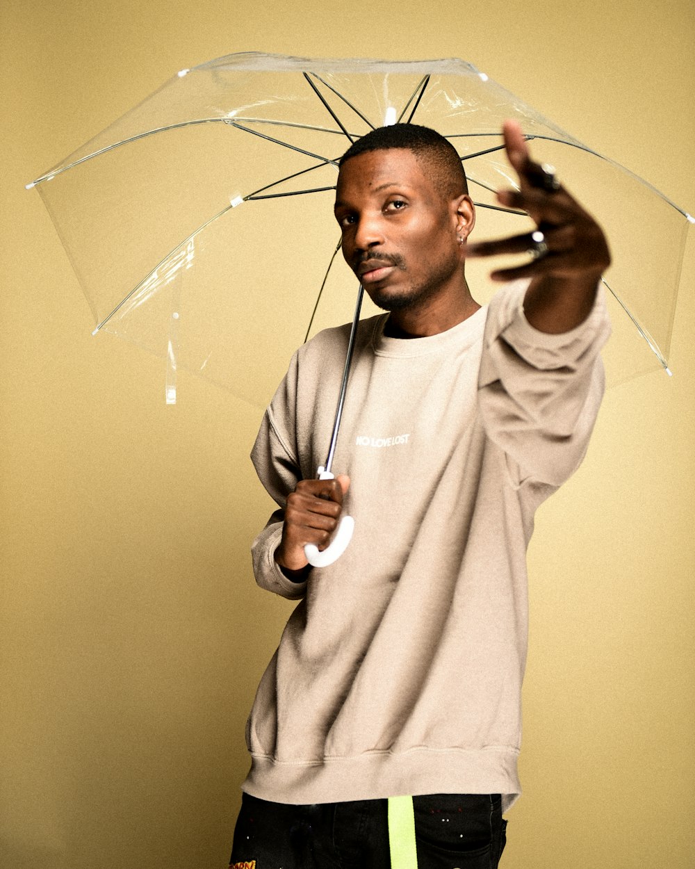 man in white robe holding umbrella