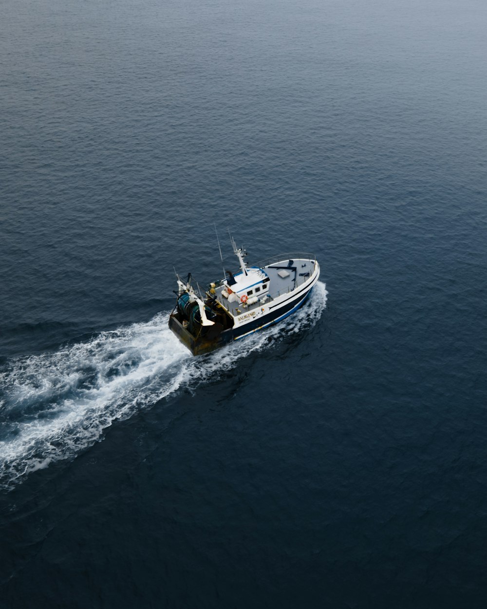 white and black boat on sea during daytime