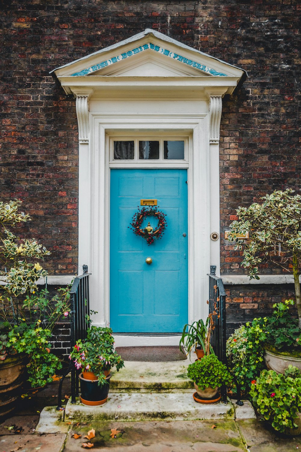 blue wooden door on brown brick building