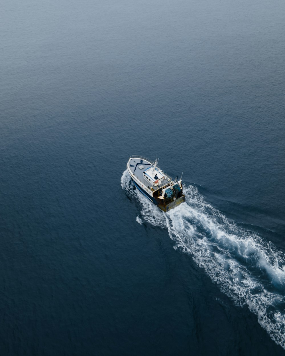 white and black boat on blue sea during daytime