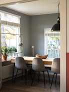 black metal framed white padded chairs