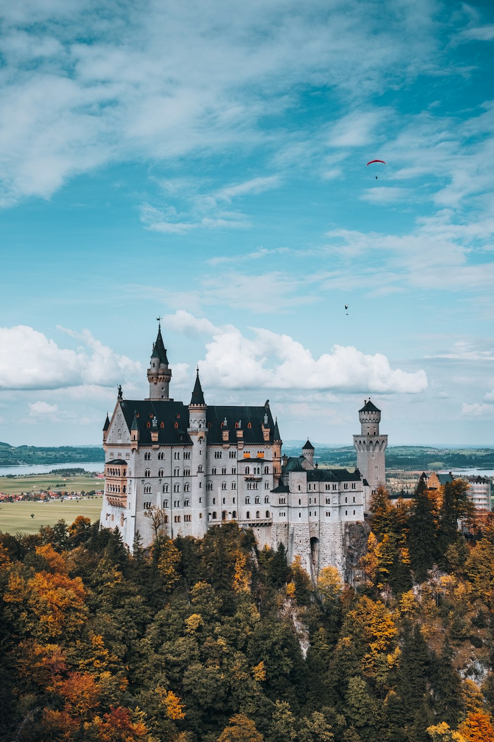 white and blue castle near body of water during daytime