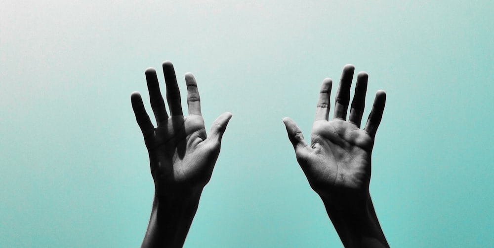 persons hand with black manicure