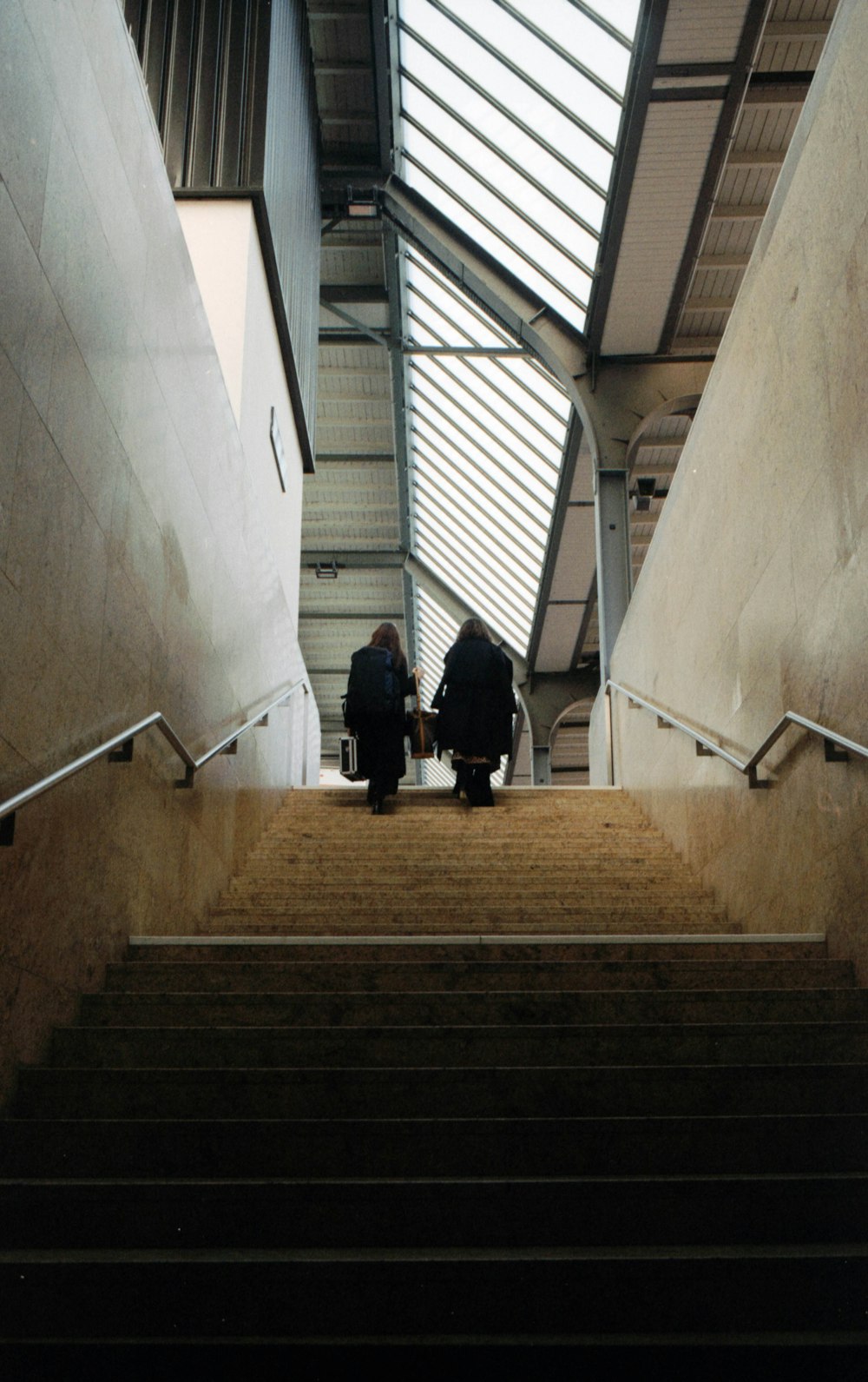 man in black jacket walking down the stairs