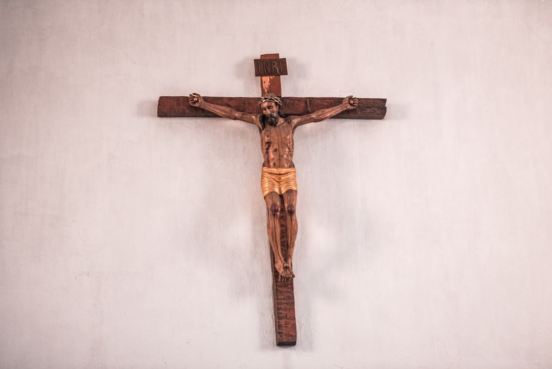 brown wooden cross on white wall, Imagen antigua de Cristo clavado en la cruz sobre altar del Templo Mercedario en Antig