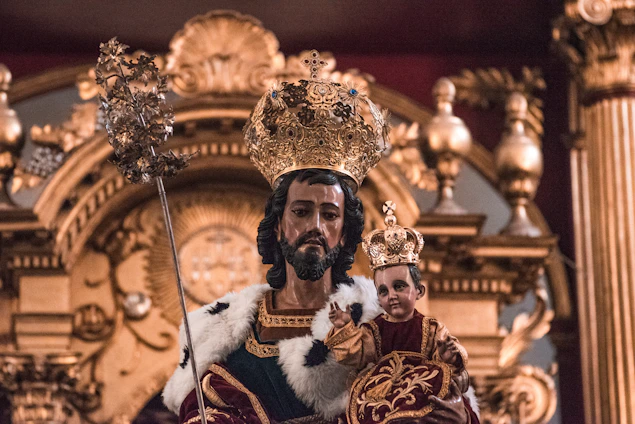 A regal portrait of King Kosoko in traditional Yoruba royal attire, set against a backdrop of deep royal blue and antique gold accents.